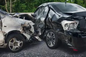 Two heavily damaged cars after a side-impact collision.
