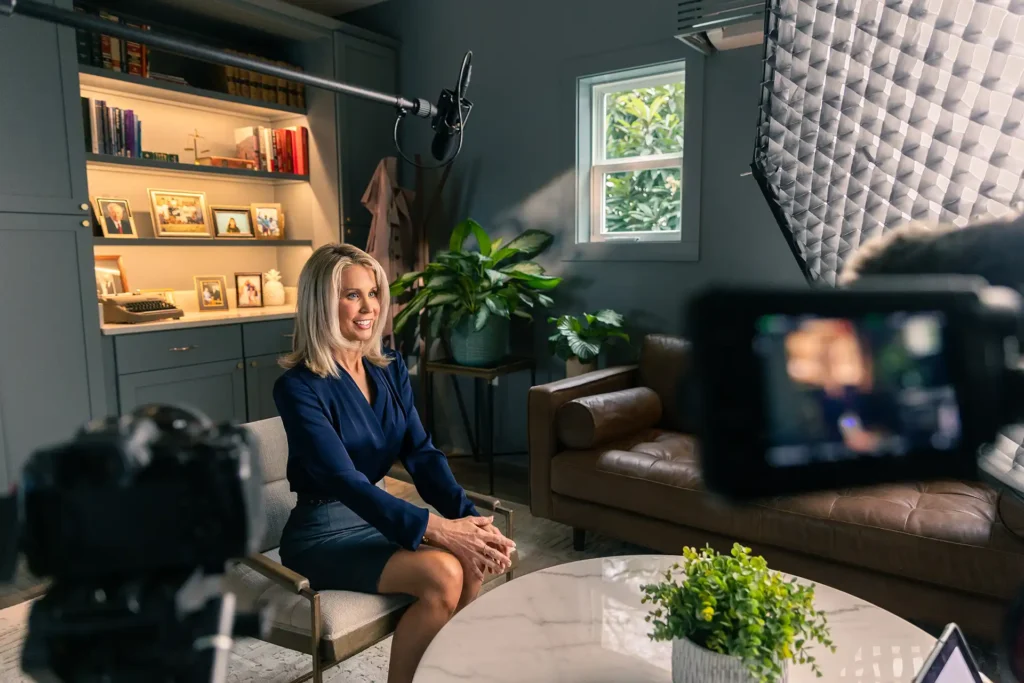 rebecca franklin harris seated at a chair in front of a professional camera