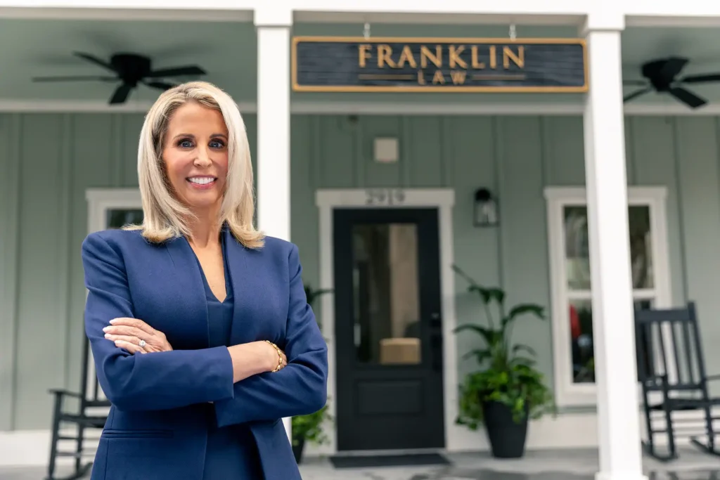 Brunswick Personal Injury Lawyer - Franklin Law, LLC. rebecca franklin harris standing in front of a sign hanging above her office door