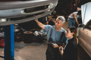Mechanic checking underside of a car